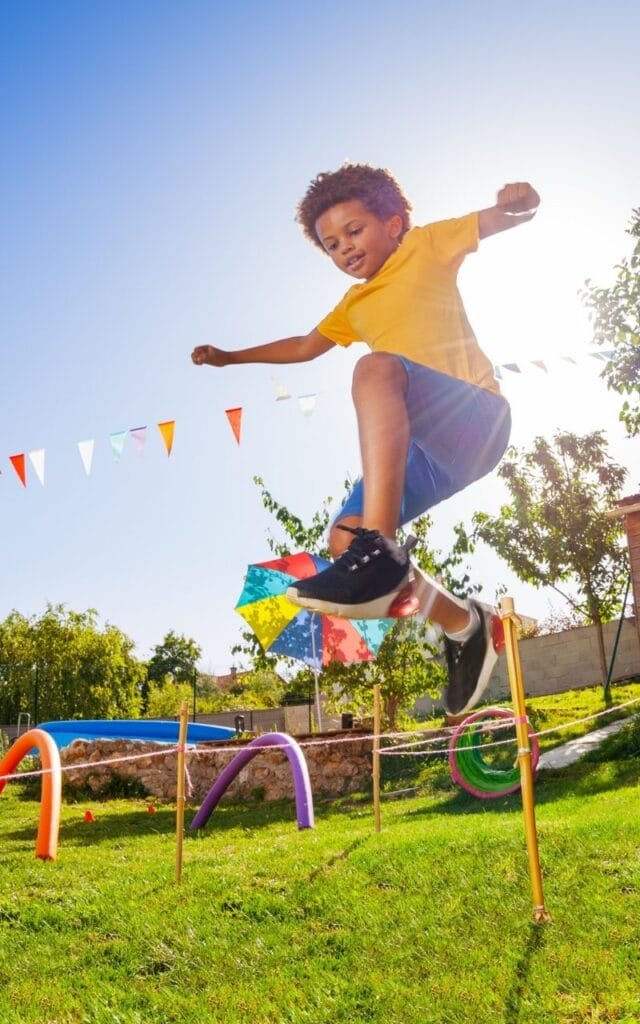 boy-jumping-in-air-over-obstacle-course