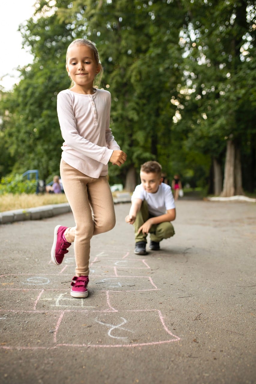 happy-kid-playing-hopsotch-outdoors